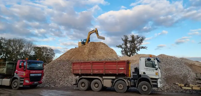 Camion-benne De Paepe Terrassement chargé en gravats sur une plateforme de recyclage